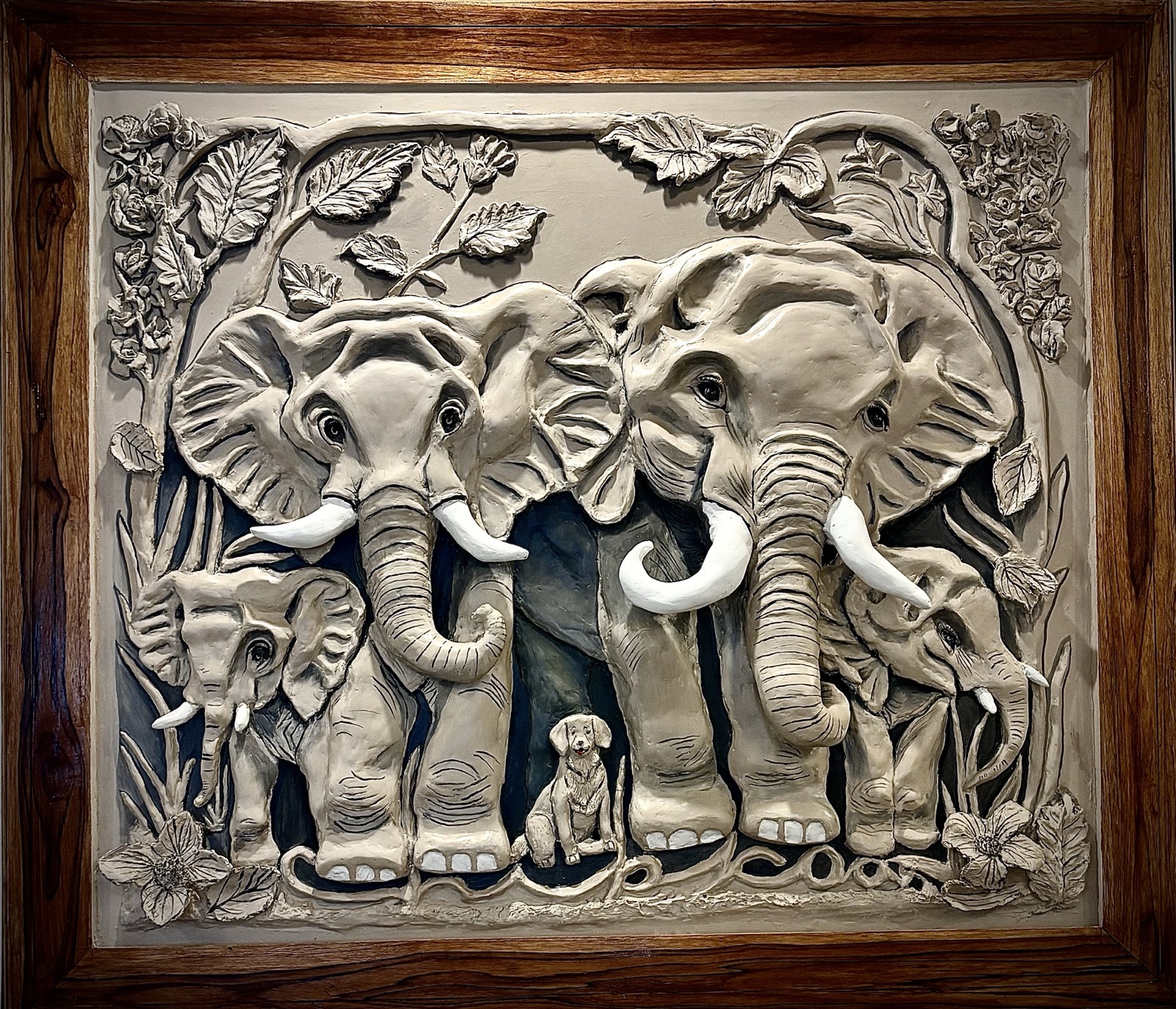 An Ode to Togetherness — a putty relief mural of an elephant family